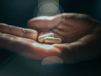 person holding pills in their hand