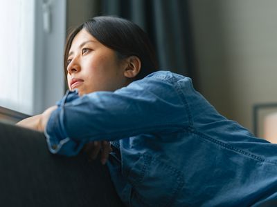 person depressed near window