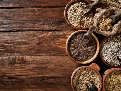 Dietary fiber: variety of cereals on rustic wooden background 