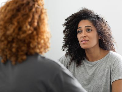 two people looking at each other sad