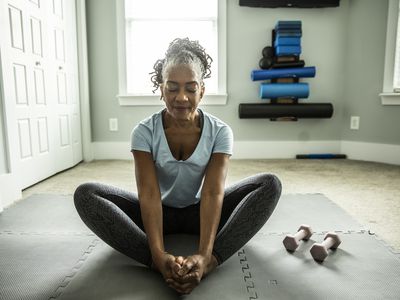 Older BIPOC woman stretching