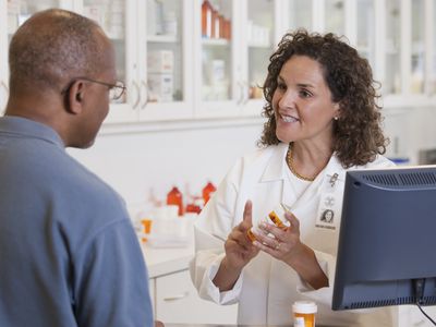 Pharmacist talking to customer about prescription