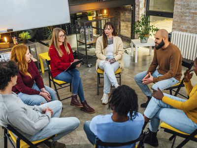 Group of people sitting in a circle on group therapy