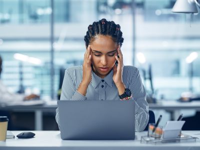 Young woman Office Worker Uses Laptop, Feels Sudden Burst of Pain