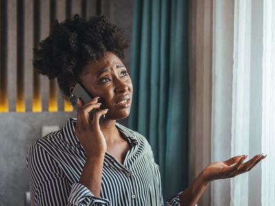 Outraged attractive employee talking on the phone, arguing with a client or customer, actively gesturing, a business woman who is seriously talking on a smartphone, solving a business problem