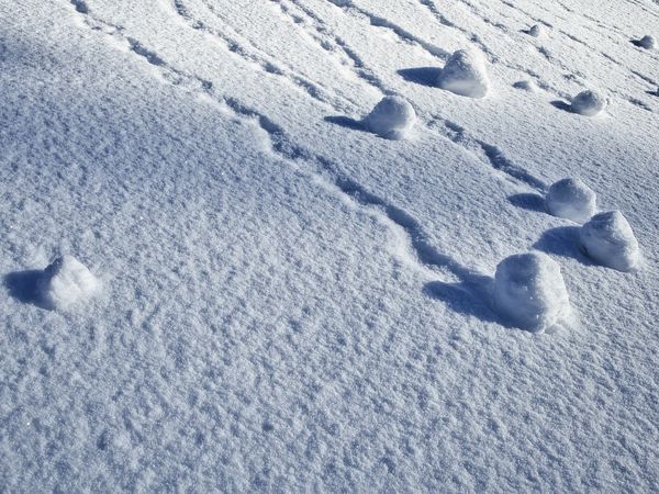 snowballs rolling down a hillside