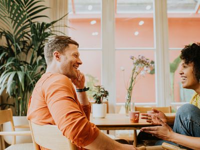 A man and a woman look relaxed as they have a lighthearted conversation