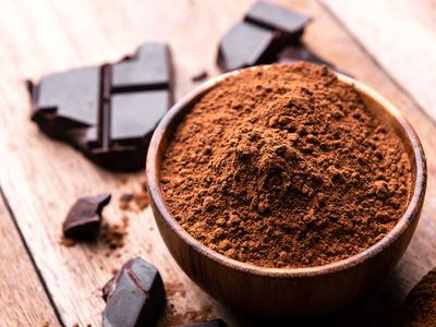 crude dark cocoa powder in a brown bowl