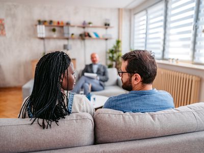 Young mixed race married couple having a marriage counseling session to fix the problems in their relationship.