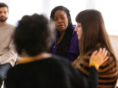 Support group consoling and encouraging a woman during session