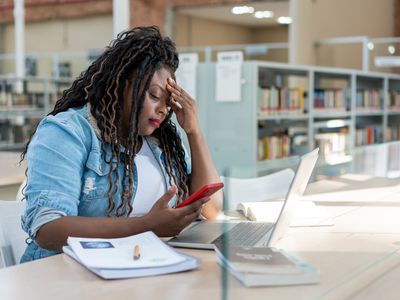 An adult woman studying in the library