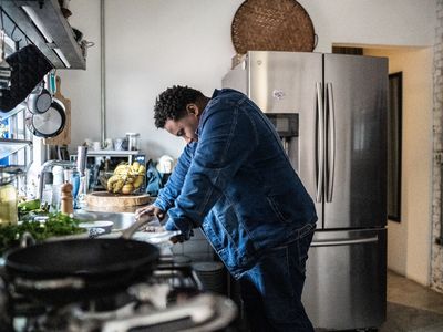 Sad mid adult man in the kitchen at home