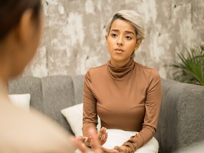 Young Queer persons engaged in a counselling session.