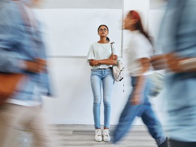 Student, anxiety and woman in busy college campus with depression, sad and mental health problems. Burnout, stress and tired girl thinking about exam, assignment or project deadline at university