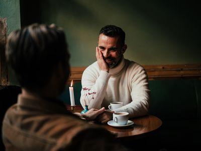 Gay male couple on a date in a coffee shop