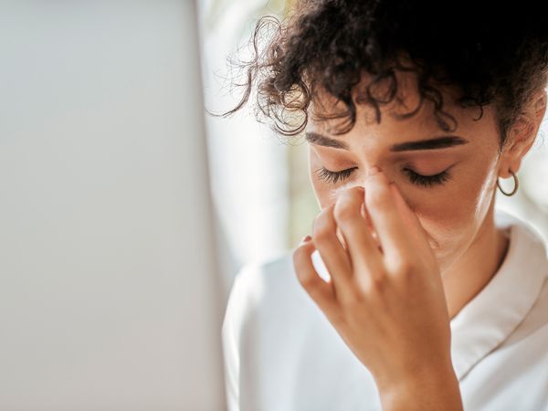 Stress, headache and business woman feeling upset and overwhelmed with distresed employee. Stressed, unhappy and female business intern suffering with a migraine after business fail or mistake