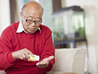 senior asian man taking medication