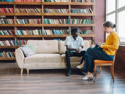 Young Black man talks with a female therapist