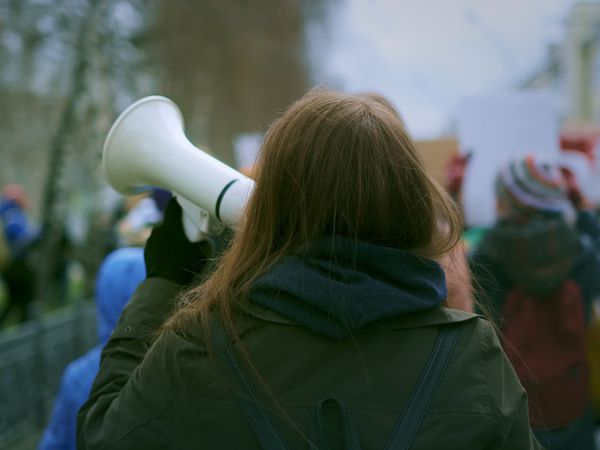 Young woman at demonstration in the city.