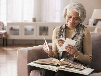 Older lady looking at photos on the couch