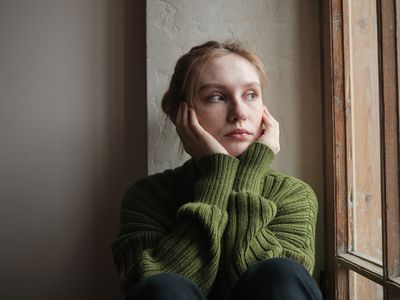 upset girl looking out window