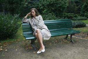 Woman sitting on bench in park