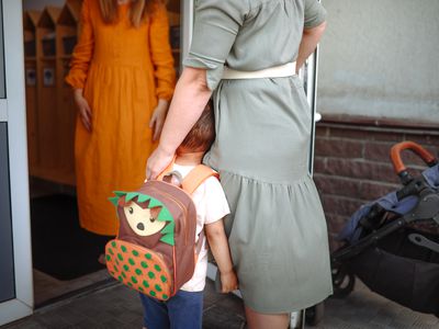 Daughter greets mom with toddler at the door of a house