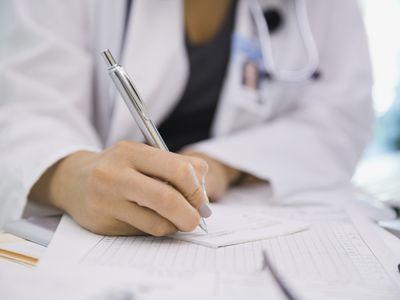 Female doctor writing prescription