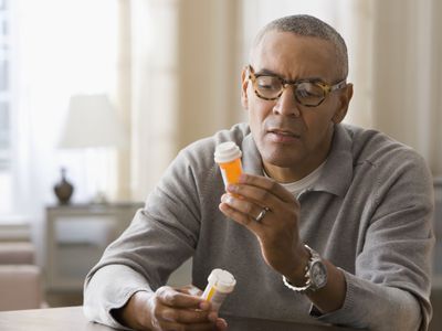 Man holding prescription drugs.