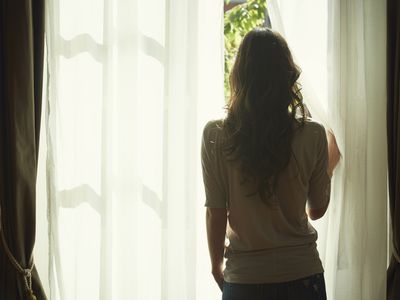 Woman looking out window