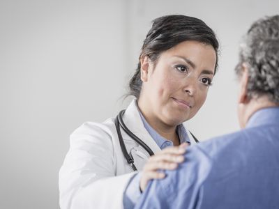 Doctor comforting senior patient