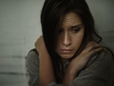 A young woman looking anxious and fearful