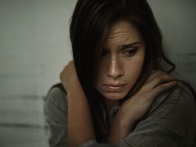 A woman with schizophrenia looking scared.