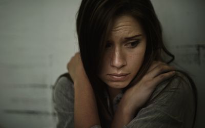 A woman with schizophrenia looking scared.