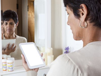 Woman researching medicine on a cell phone