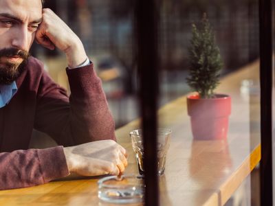 Sad man at bar dissociating related to childhood trauma