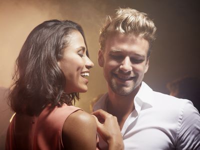 Happy multi-ethnic young couple enjoying at nightclub