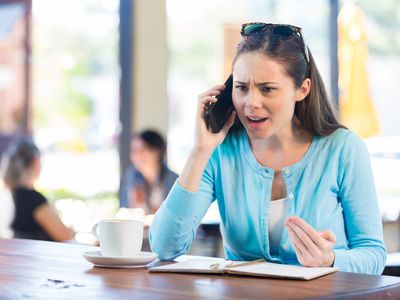 Woman making angry phone call in local coffee shop