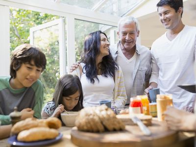 Multi-generation family eating in kitchen