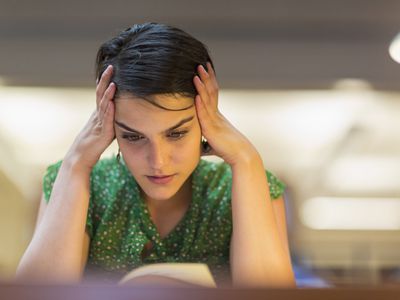 stressed woman with hands on head