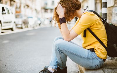 Sad teenage girl at the street