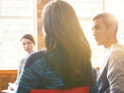 Man listening in group therapy session