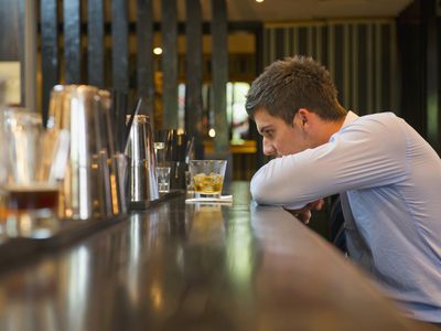 Lonely businessman sitting at bar