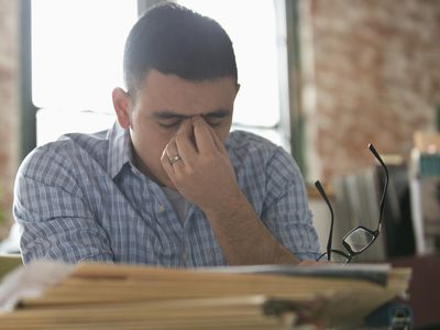 Stressed man with headache at desk