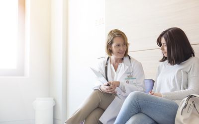 young woman and doctor talking