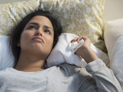 person depressed laying in bed