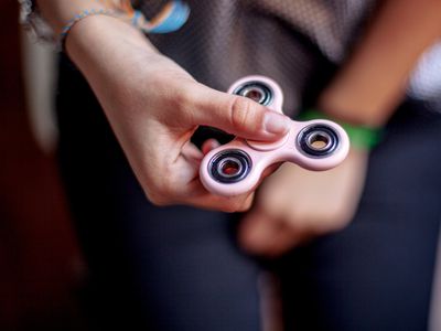 person holding fidget spinner