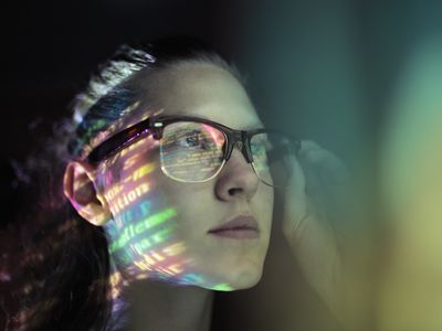 Woman with images reflected in glasses