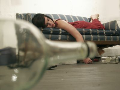 A woman lying on a couch.