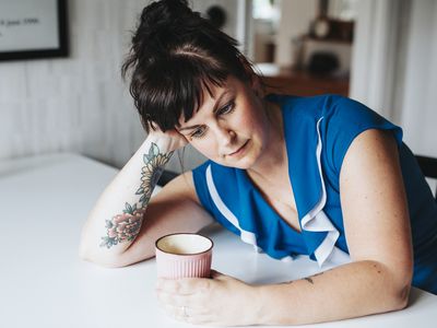 Woman stressed at her kitchen table